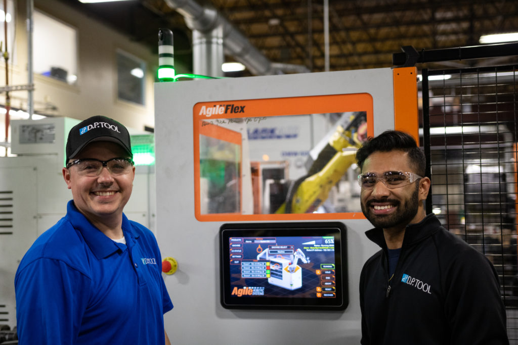 Employees standing next to Agile panel
