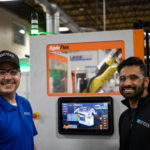 Employees standing next to Agile panel